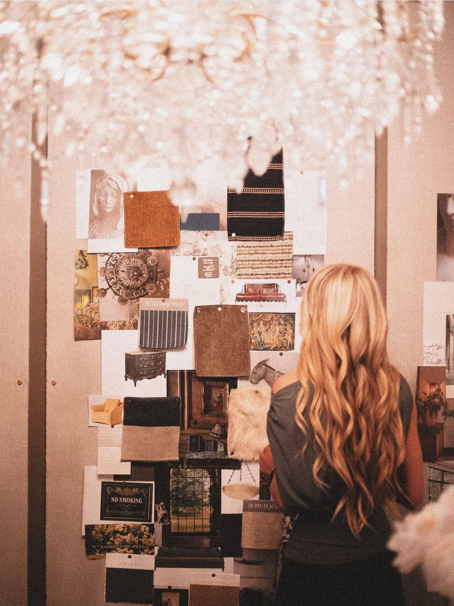 A designer reviewing a mood board in a studio