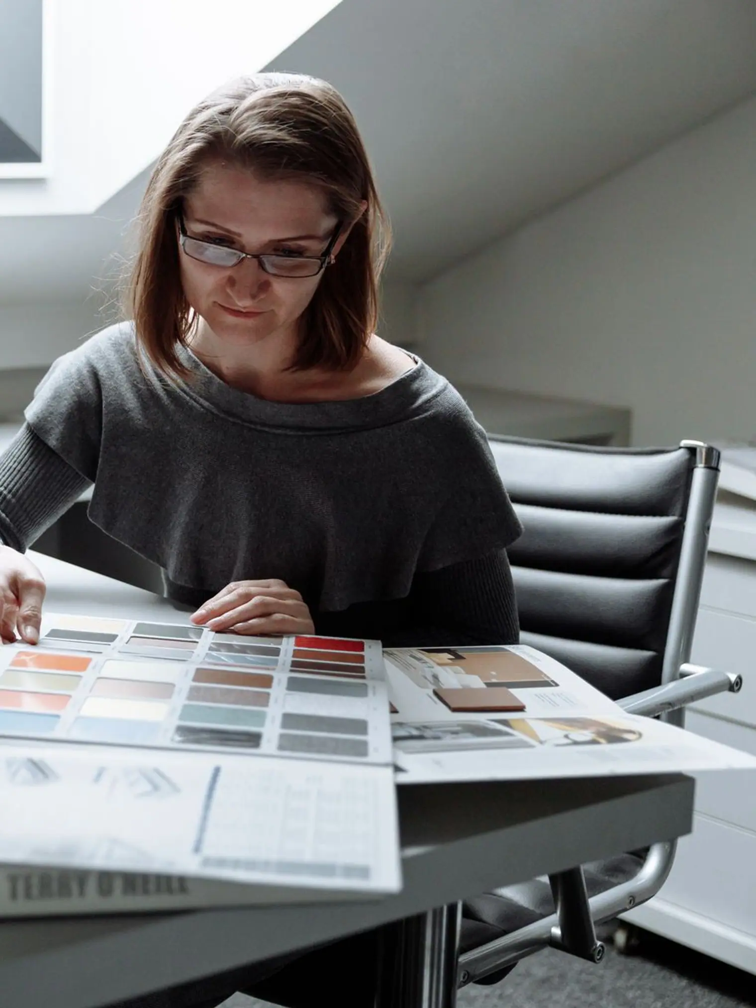 A designer comparing colour palettes at a desk