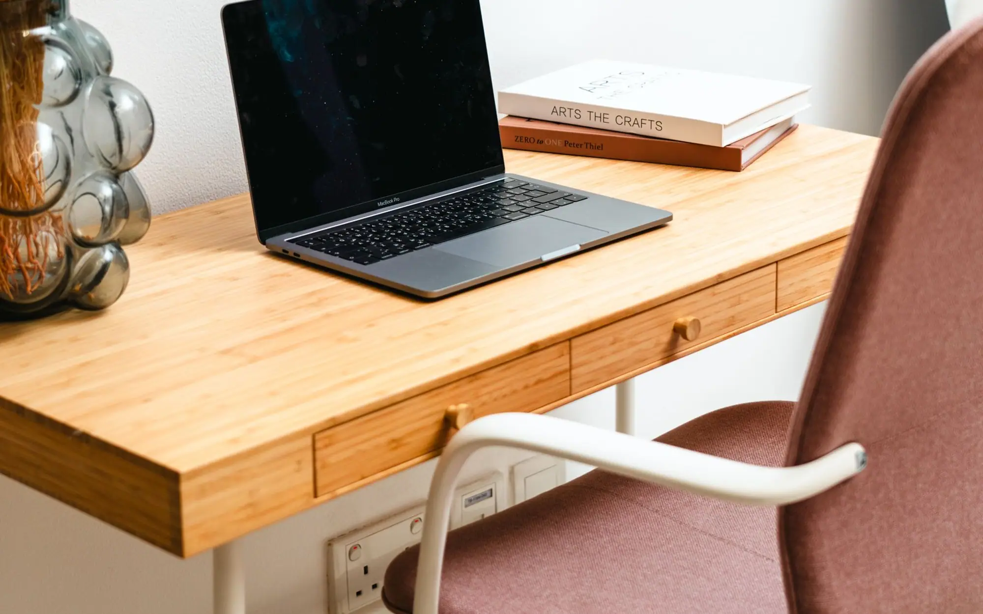 A modern minimalist desk setup with books