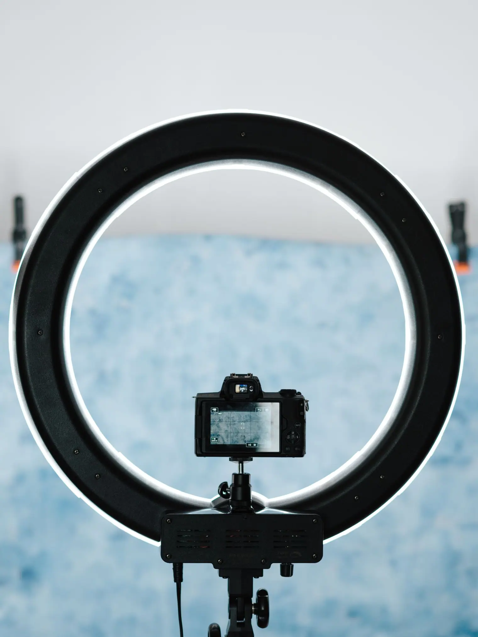 A bright LED studio lamp beside a camera