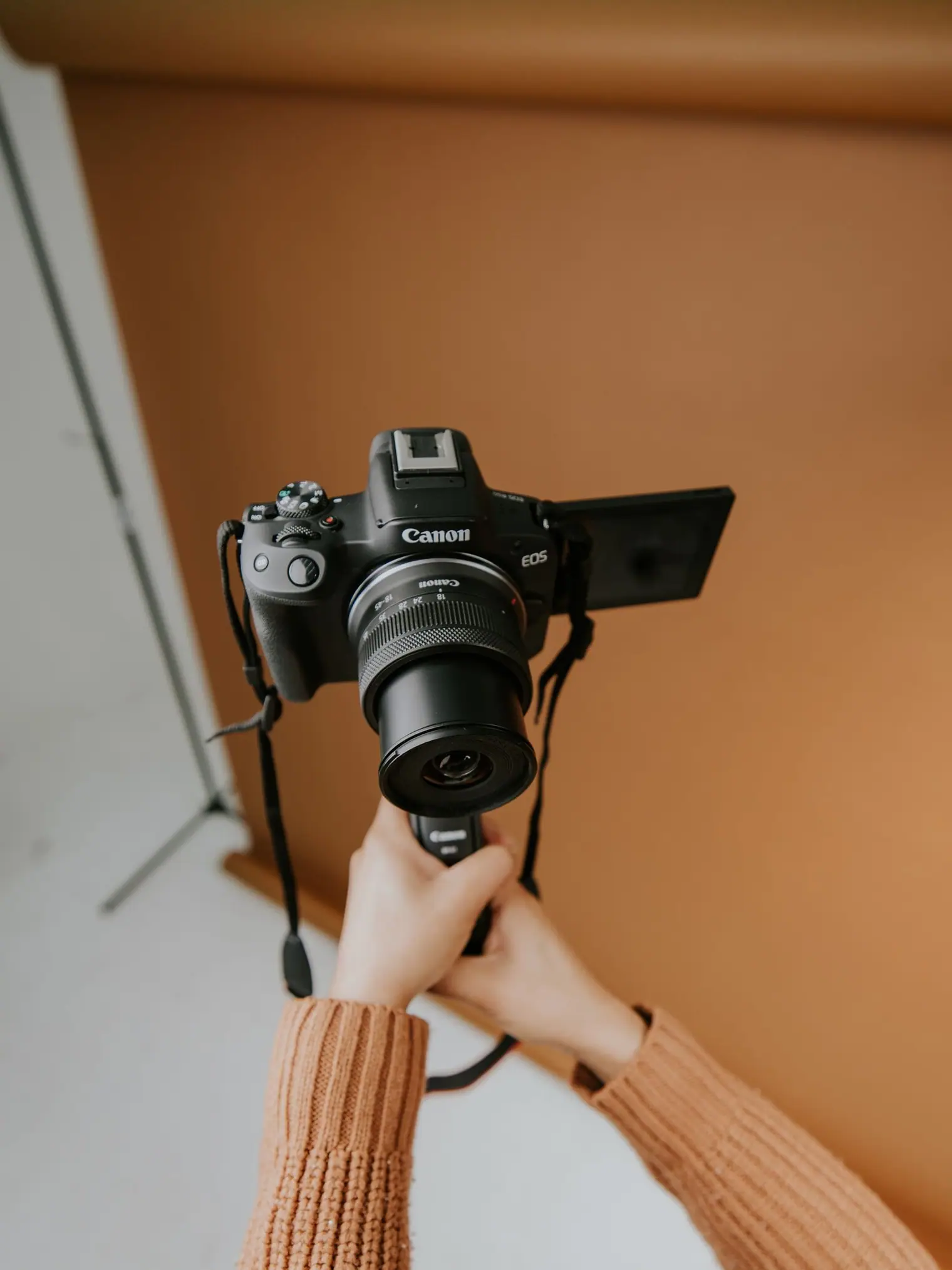 A photographer with a camera under studio lighting