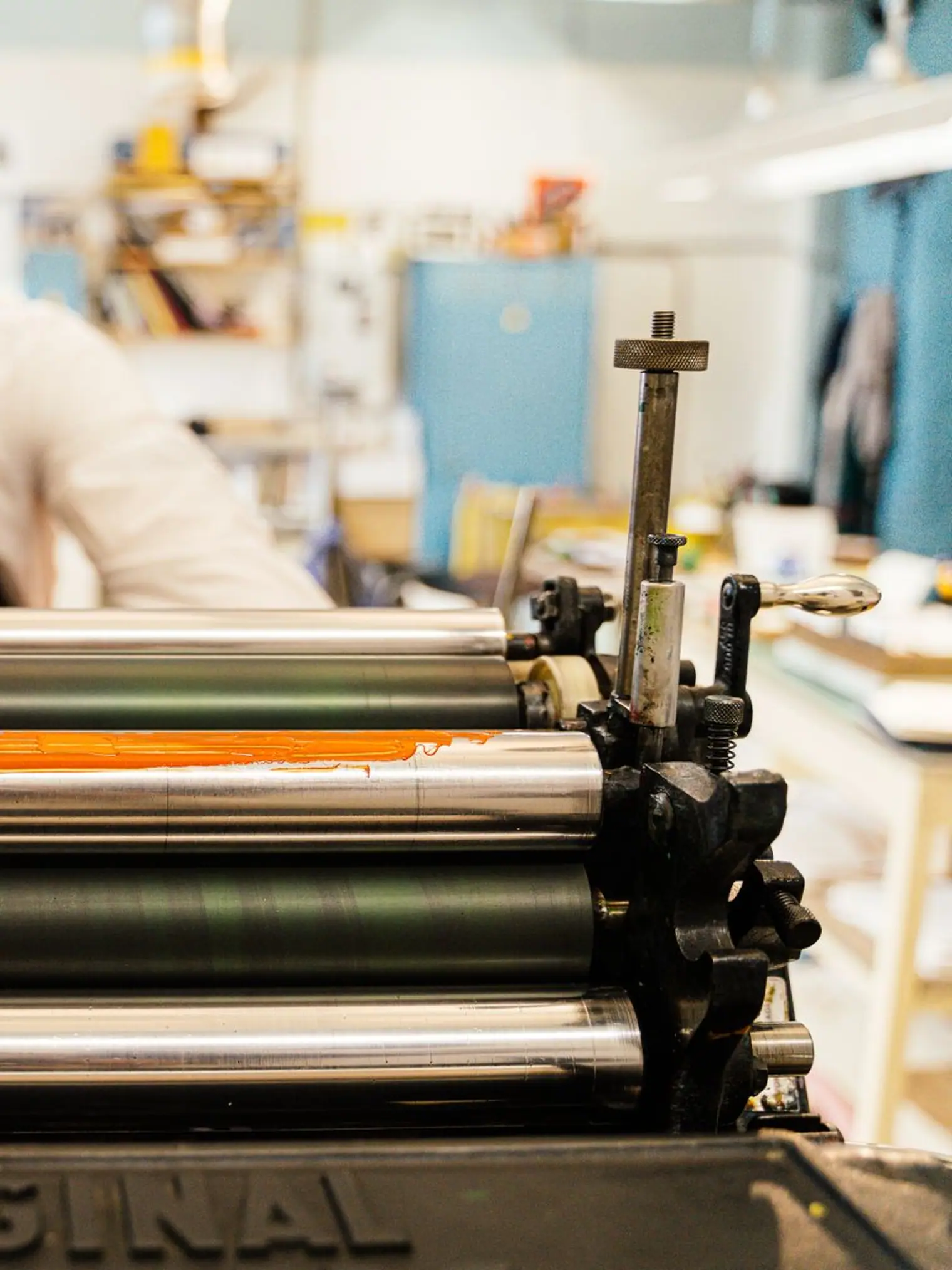 Operating a vintage printing press in a workshop