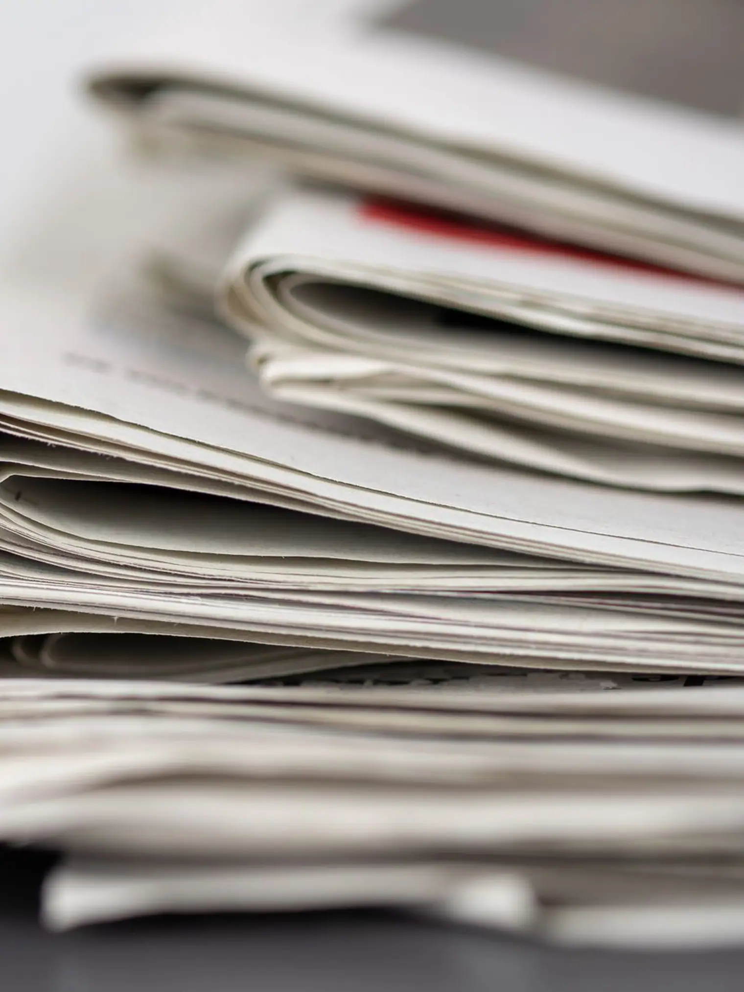 Folded newspapers stacked flat